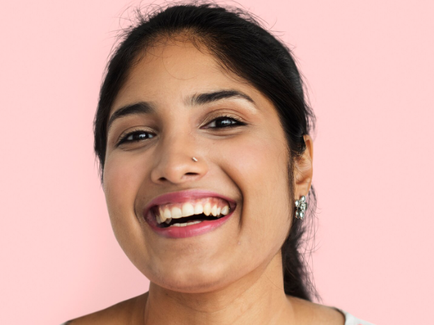 Smiling Indian woman with healthy, glowing skin, representing Hydrafacial suitability for Indian skin types.